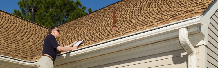 worker inspecting roof