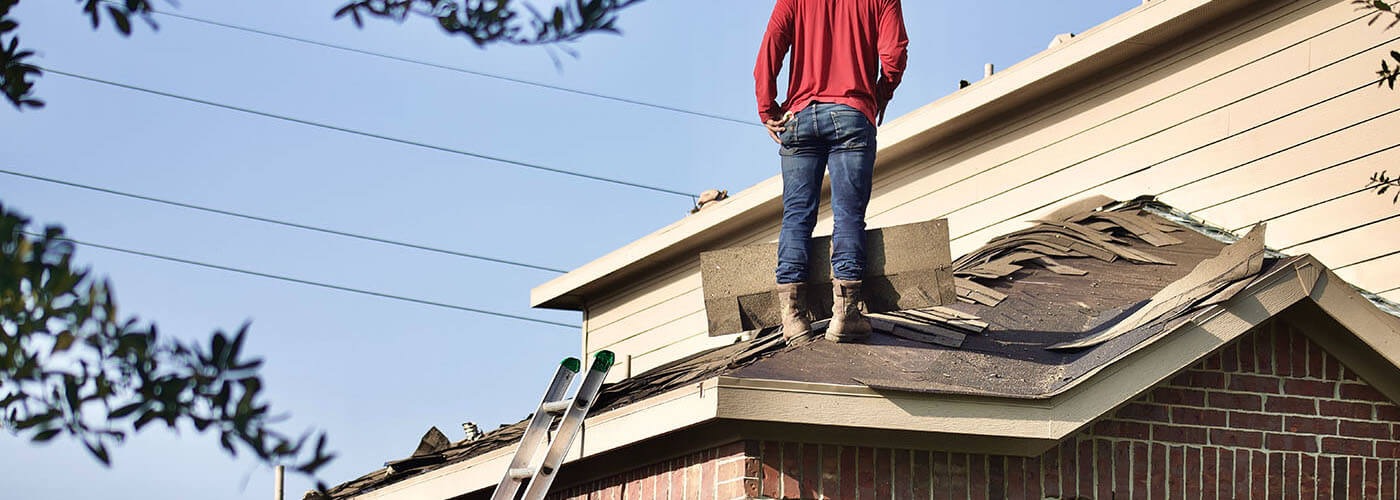 roofer performing emergency roof repair